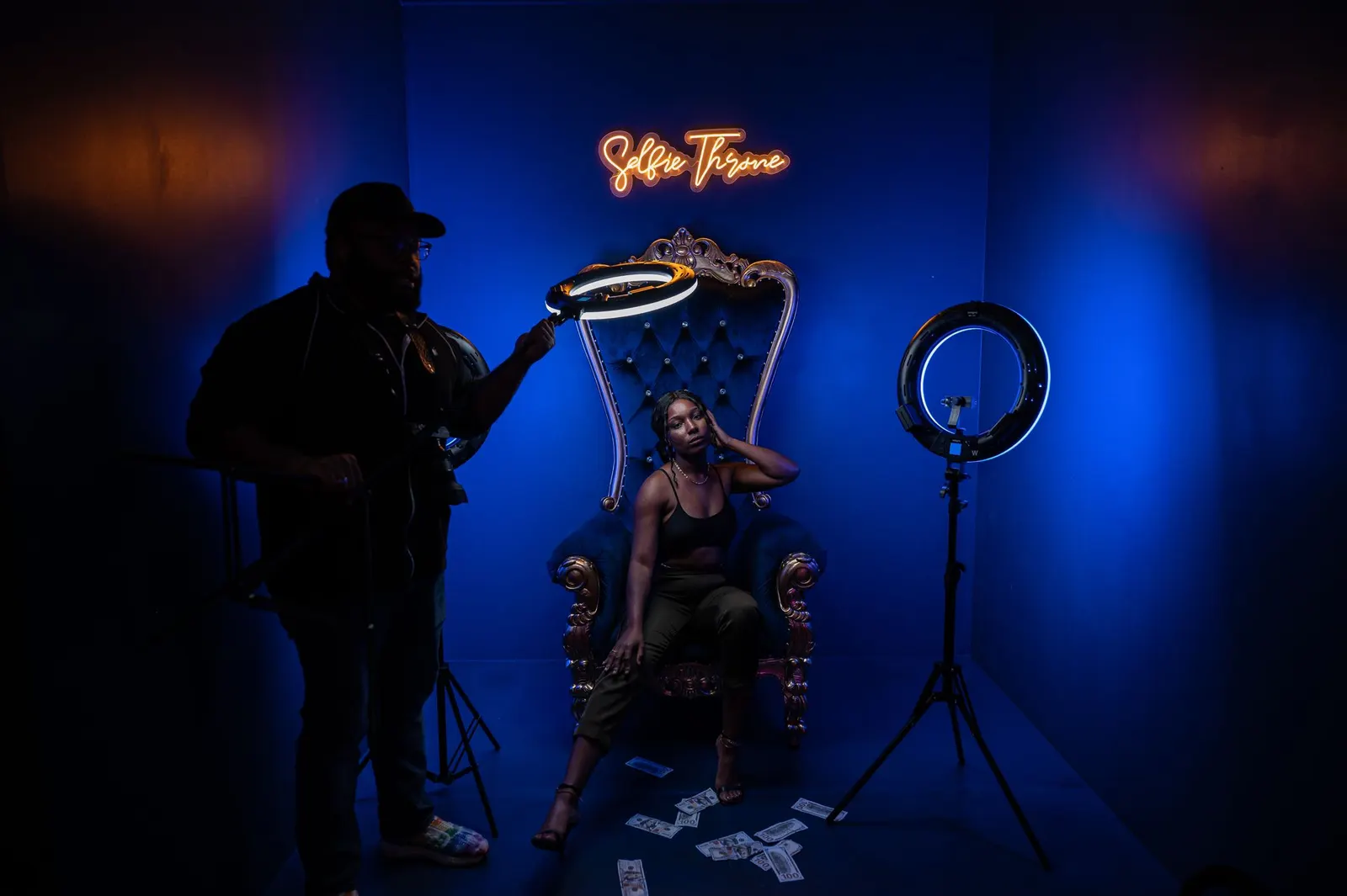 A ring-lit photo booth seat in a dark room