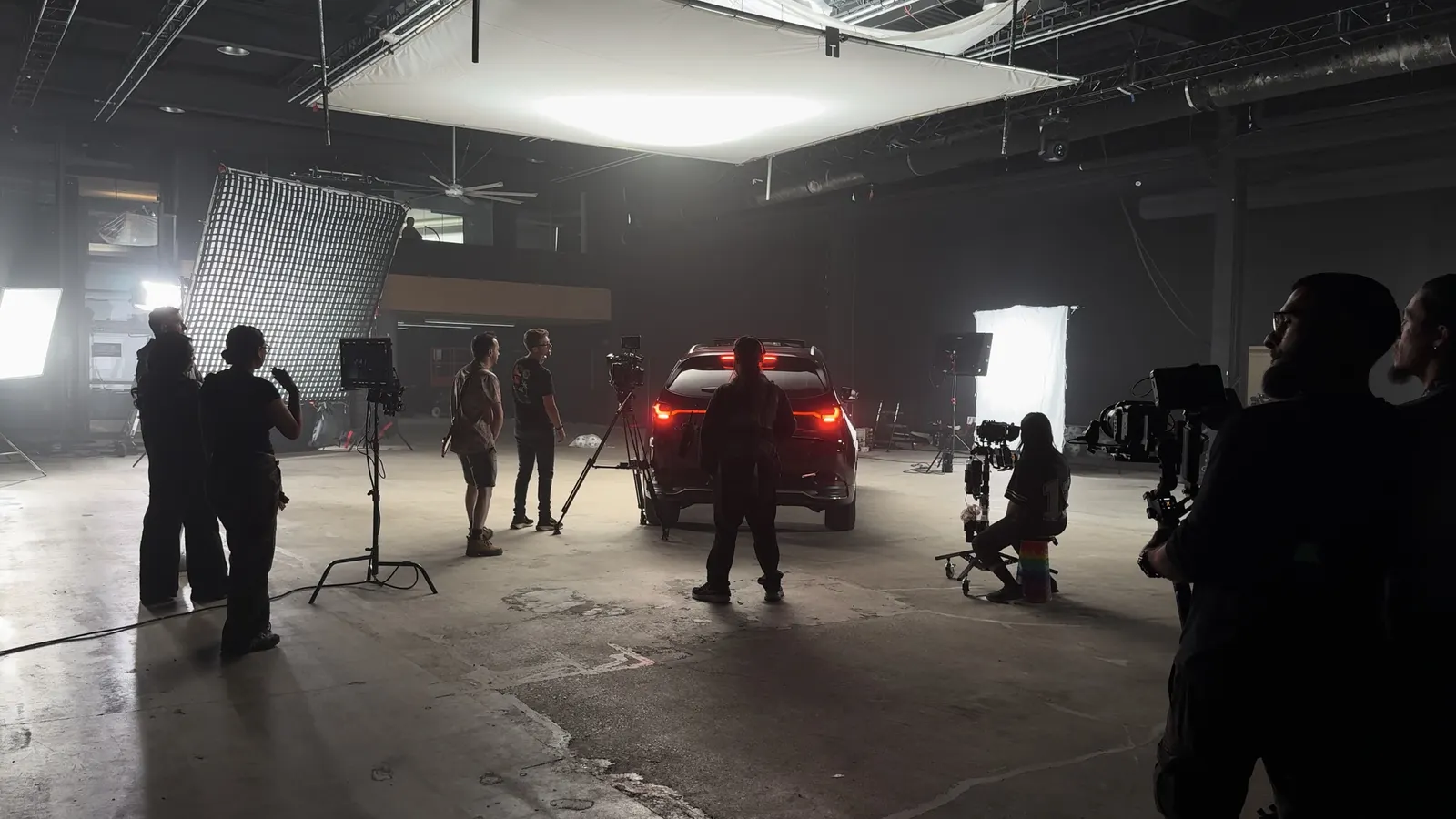 A car shoot in Demo Room, crew, lights and cameras around the vehicle