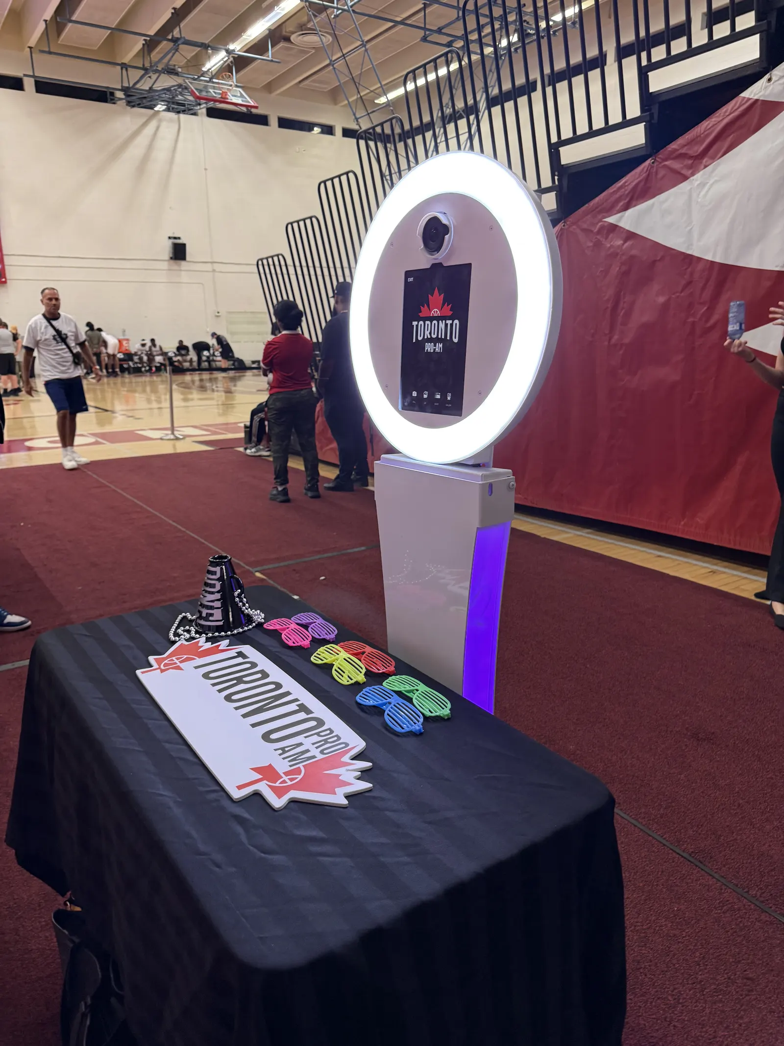 A ring-light photo booth with a props table at a school event